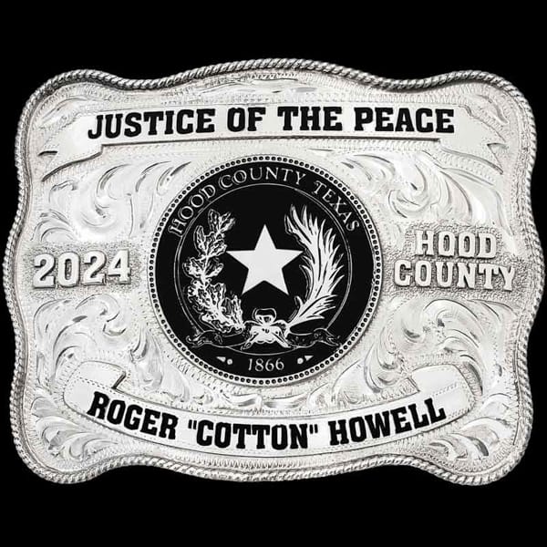 "Justice of the Peace: Upholding fairness, one community at a time. Our Brazos Bend Belt Buckle, crafted from German Silver, features a hand-engraved design with a classic rope edge. Two banners display hand-painted enamel text on the top and bottom,